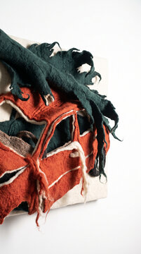 Felt craft artwork depicting a damaged car and abstract elements  
