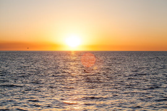Sunset over the Gulf of Fonseca in Cede&ntilde;o, Choluteca, Honduras, with golden light reflecting on the sea and a warm orange sky over the horizon.