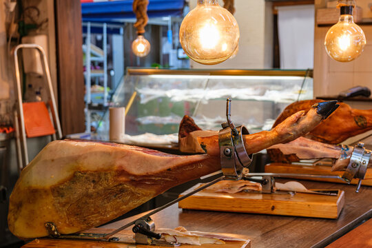 Spanish dry-cured ham in a traditional jamonero holder at a market stall in Las Palmas de Gran Canaria