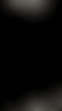 Warm white film burn overlay, a film burn blooming from one edge, seamless looping black background film texture for video editing, vertical 9:16