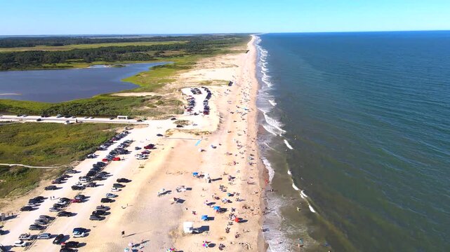 Beach parking and an access road border coastal wetlands near Chincoteague in Virginia.