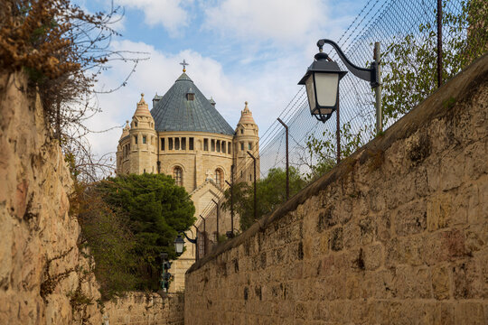 Jerusalem, Israel, 26 September 2026. View of  Church of the Dormition from a narrow stone lane, with its distinctive round structure and conical roof.