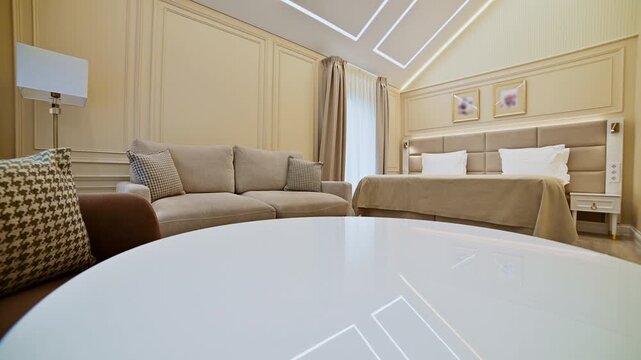 Panning shot of luxury hotel bedroom and sitting area