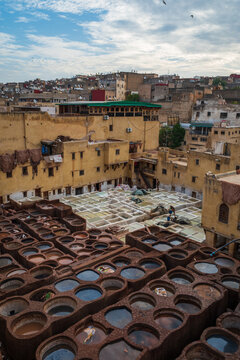 vertical the intricate network of stone dyeing vats and narrow separating partitions at the ancient tanneries in Fes, Morocco
