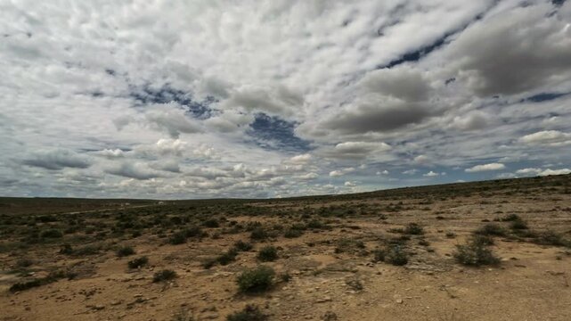 Tracking shot over arid semi desert landscape