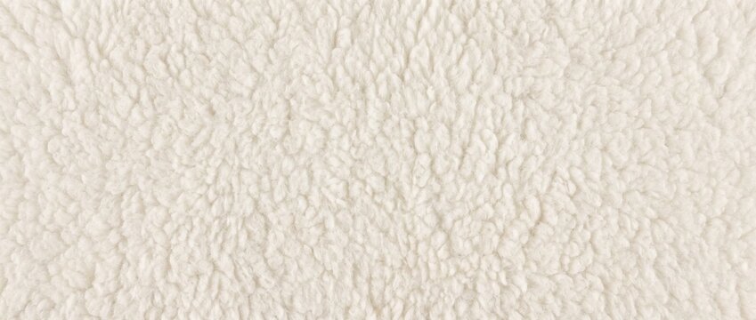 Soft white polar fleece texture background. Fluffy sherpa faux fur textile macro. Warm woolly sheepskin fabric backdrop with copy space