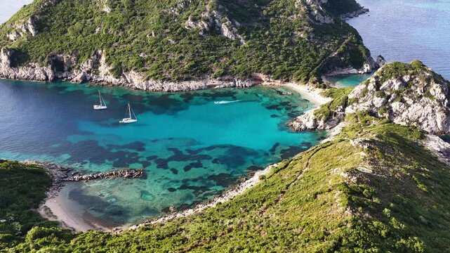 Aerial view of blue waters and green hills at Porto Timoni in Corfu Greece