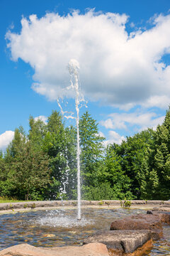 fountain at city park viechtach, green trees and blue sky with clouds