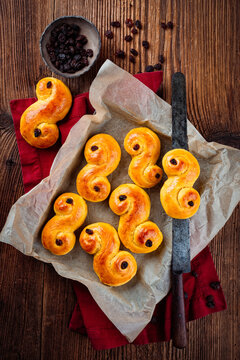 Classic artisan homemade  traditional Swedish  St Lucia buns lussekatter served as top view on baking paper