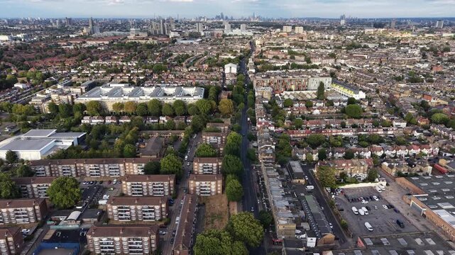 Aerial view over the Vale Acton, London, showcasing residential sprawl leading to the city skyline and The Shard in the distance.