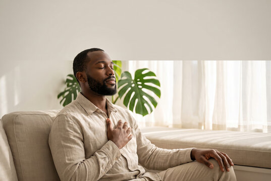 Man practicing mindful breathing on a window seat at home