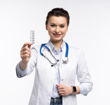 Attractive woman qualified specialist therapist wear white doctor robe hand hold pills isolated on white background.
