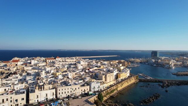 Gallipoli, Salento, Apulia, Italy &ndash; Drone shot of the houses along the promenade featuring the Church of the Most Holy Trinity and the Souls in Purgatory