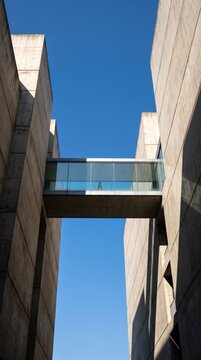 Glass bridge connecting two concrete towers as metaphor for connection and human passage