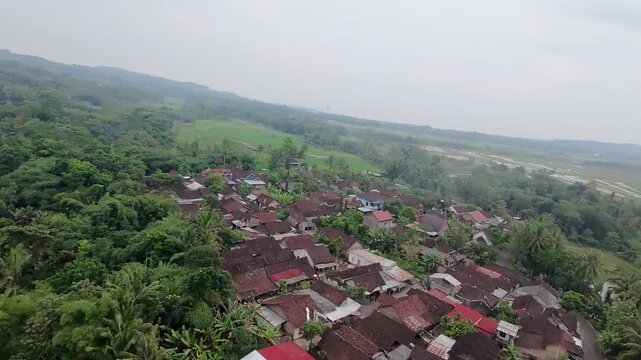 Drone shot of peaceful countryside road and paddy fields in Java