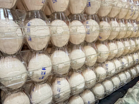 Stacked White Eggs in Plastic Cartons at Mexican Market &ndash; Fresh Food Retail Background Closeup