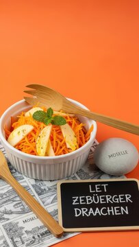 L&euml;tzebuerger Draachen Luxembourgish Carrot and Apple Salad with Mint on Orange Background