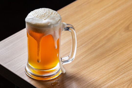glass of beer on wooden table