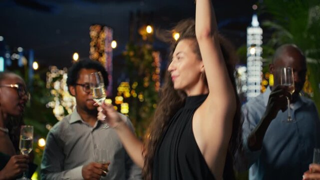 Close up of woman dancing with champagne flute in hand at party