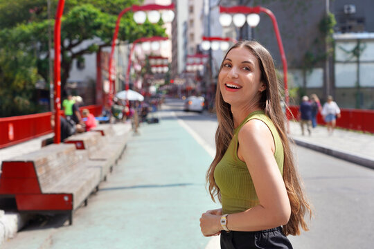 Tourism in S&atilde;o Paulo. Young Brazilian tourist woman walking in the Liberdade neighborhood of S&atilde;o Paulo, Brazil.