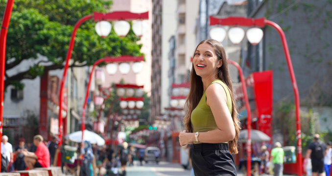 Visiting Sao Paulo, Brazil. Panoramic banner view of Brazilian tourist woman walking in the Liberdade neighborhood of Sao Paulo, Brazil.