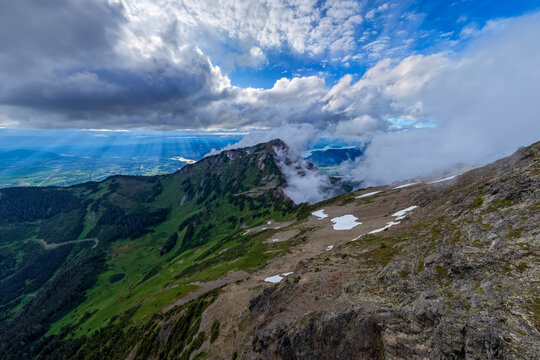 Dramatic Mountain Landscape Overlooking Chilliwack Valley With Clouds, Sun Rays and Alpine Peaks, BC Canada