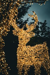 Detailed close-up of a glowing reindeer Christmas light sculpture outdoors at night © yasmin
