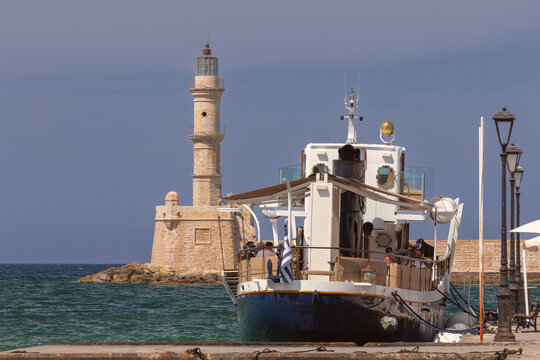 Chania Lighthouse and Passenger Boat in Old Venetian Harbor, Crete