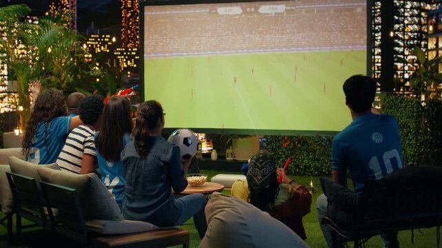 Upset spectators watch a soccer match and react angrily to a referee decision, after a red card eliminates a player from their favorite team.