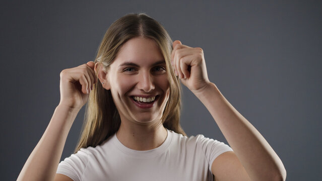Young woman smiling with arms raised expressing joy and winning