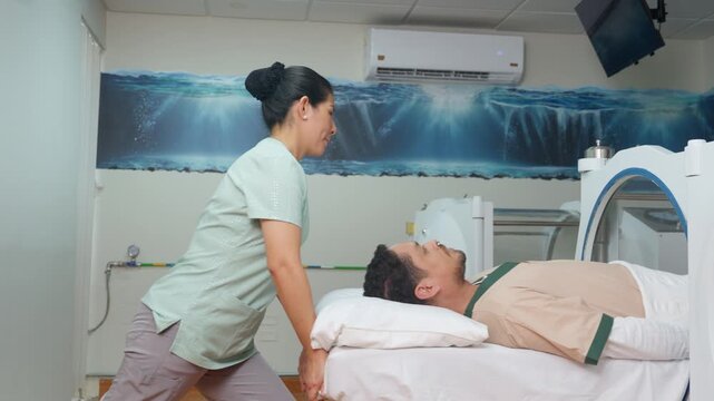 Nurse assisting patient into hyperbaric oxygen therapy chamber