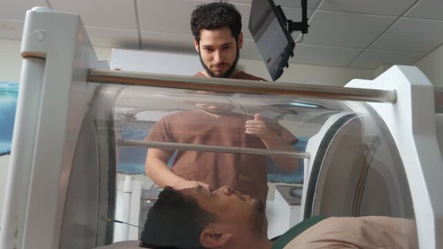 Specialist preparing patient for hyperbaric oxygen therapy session
