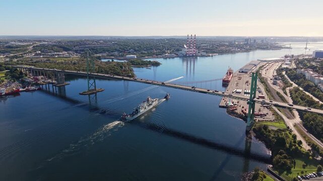 Military ship towed through Halifax harbor in Nova Scotia, Canada