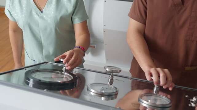 Medical staff operating hyperbaric oxygen therapy chamber