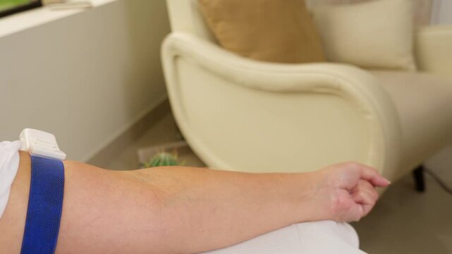 Nurse preparing patient arm for vitamin infusion therapy