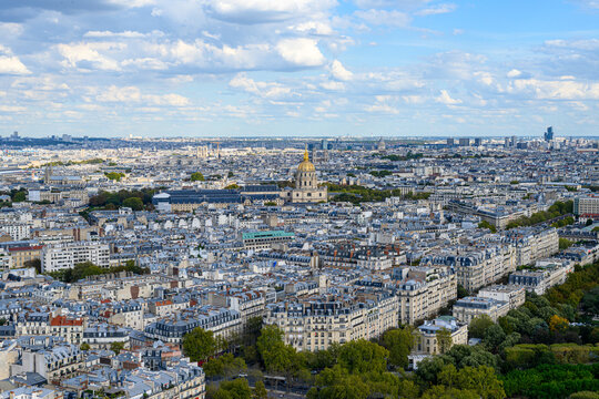 Paris sprawls beneath a partly cloudy sky