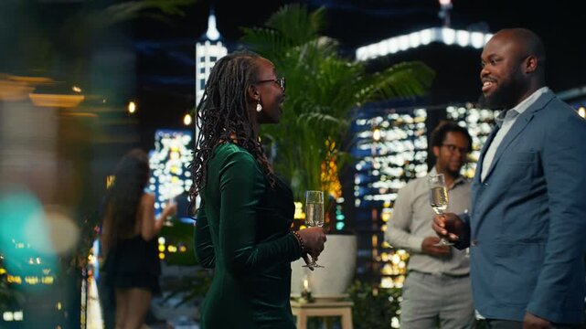 Smiling woman and man greeting each other at elegant social gathering
