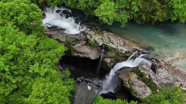 A waterfall flows through green forests and rocks, embedded in a natural landscape, aerial view, Martvili Gorge, Martvili Canyon, village of Intschchuri, Abasha River, Martvili municipality, Mingreli
