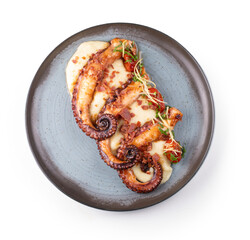 Top-down view of a gourmet dish featuring three tentacles of cooked octopus served with creamy vegetable-infused mashed potatoes, isolated on a transparent background. © mario