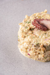 Close-up of a succulent seafood tartare garnished with an octopus tentacle  gourmet studio shot. © mario