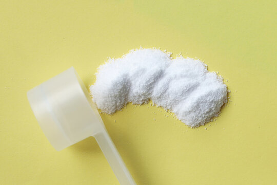 White creatine powder, used as a pre-workout supplement for gym and fitness.
