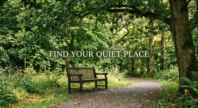 Empty wooden park bench under lush green trees on a tranquil pathway.