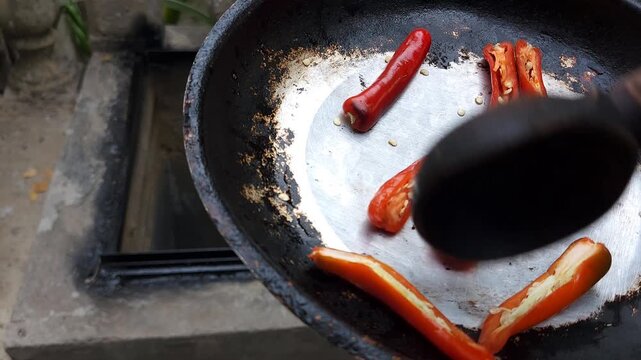 Roasting Fresh Red Tree Chili Peppers in Pan on Stove