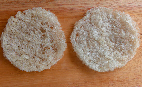Two round shape edible nest swiftlet on wooden board, raw edible bird's nest top view