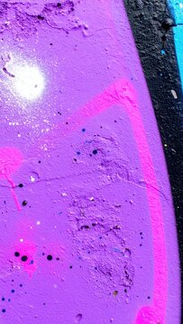 Urban street art and graffiti culture vibrant purple spray paint texture on concrete wall with abstract neon pink lines and black paint splatter
