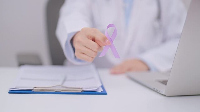 Doctor give light purple ribbon for concept of All cancer, April Esophageal Cancer, November gastric and Stomach cancer,  Hodgkin Lymphoma, Awareness month and February World cancer day concept