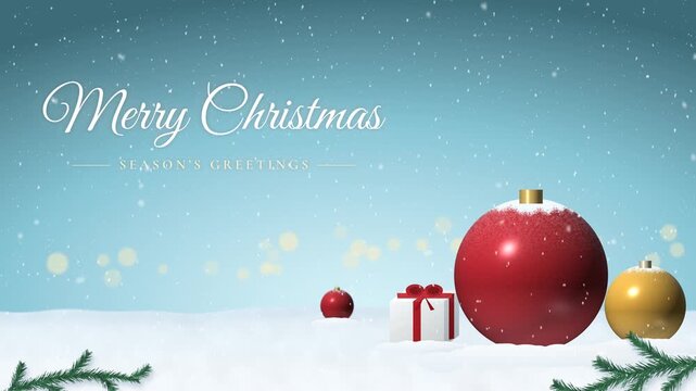 Merry Christmas script text with big red ornament, gold bauble and gift box in snow, falling snow on light blue sky