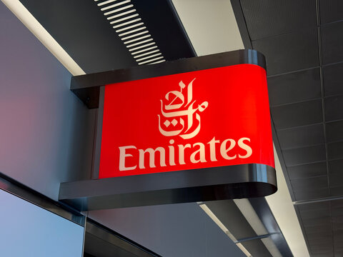 Red Emirates airline sign mounted inside a terminal at San Francisco International Airport - San Francisco, California, USA - September 4, 2026
