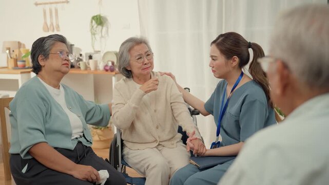 Elderly senior group sharing social interaction with caregiver in calm home setting, supportive conversation and community care, caring room nurse support and comfort for emotional health