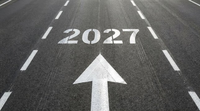 Road surface with white arrow pointing towards the year 2027, symbolizing future goals, planning, progress, and moving forward into the new year